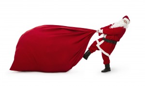 Santa Claus pulling huge bag of presents isiolated on white back